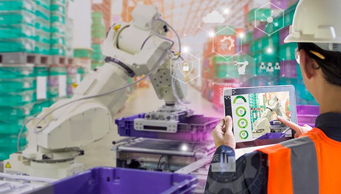 Industry 4.0 Robot concept .Engineers use laptop computers for machine maintenance, automation tools, robot arm at the factory.