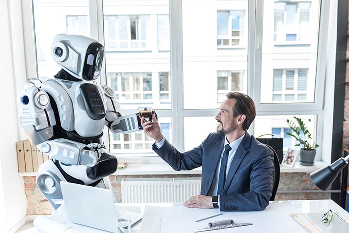 man graciously accepting a drink from a serving robot