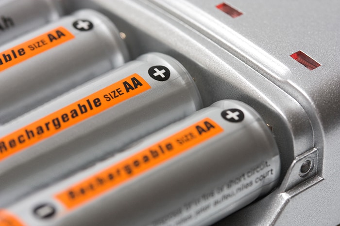 Battery charger with batteries AA background